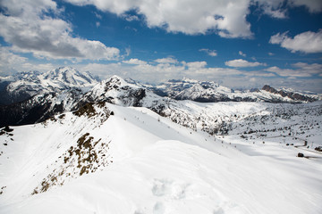 Fototapeta na wymiar Beautiful winter landscape with snow in Alps. Dolomites. Panorama of snow mountain landscape with blue sky. Sunshine. Peaks. Rocks. Alps. Italy.