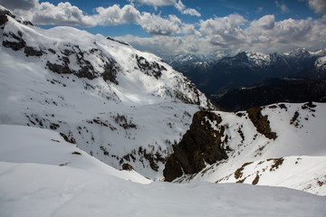 Fototapeta na wymiar Beautiful winter landscape with snow in Alps. Dolomites. Panorama of snow mountain landscape with blue sky. Sunshine. Peaks. Rocks. Alps. Italy.