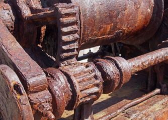 rusted cogs and gears on an old broken industrial machine