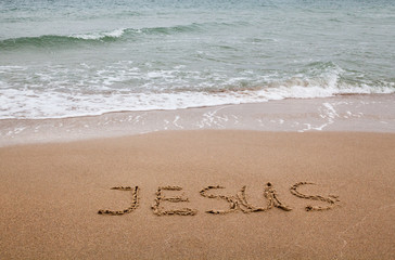 Word Jesus written on the sand