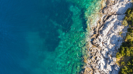 Spectacular aerial sea landscape of rocky coast and crystal clear water.