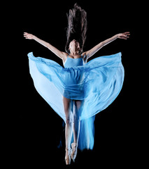 one caucasian young woman ballet dancer dancing isolated on black background with  light painting motion blur speed effect