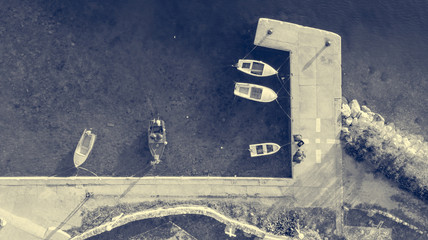 Drop down view of fishing port with boats tied in.