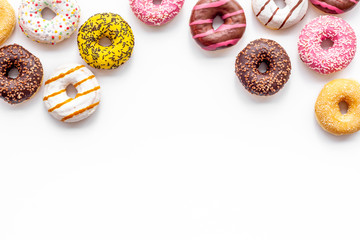 Obraz premium Modern design with bright donuts on white background top view mock up