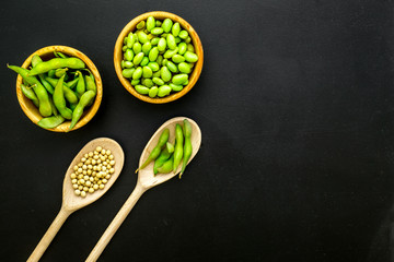 Green soybeans background on black desk top view mockup