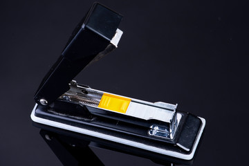 Office tacker opened with tacker staples with yellow plastic