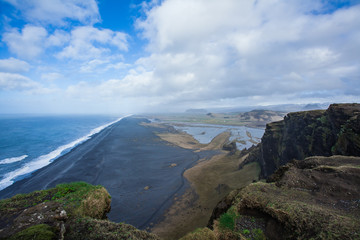 Fototapeta na wymiar landscape with ocean, black beach, mountains and blue sky