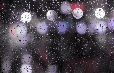 raindrops on the glass (the view from the window on the night city)