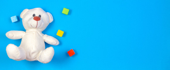 Kids toys banner background with teddy bear and colorful wooden blocks