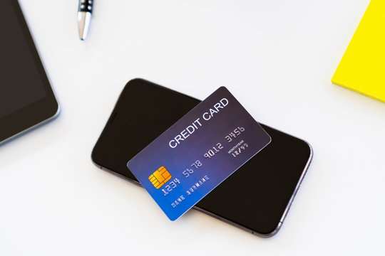Top view credit card and smartphone on desk for mobile internet banking concept
