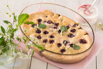 Cherry clafoutis on wooden table