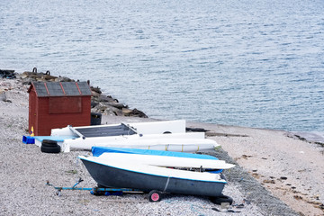 Fototapeta premium Moored small boats on beach coast by the seaside