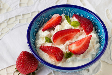 Delicious breakfast: cottage cheese and fresh strawberries.