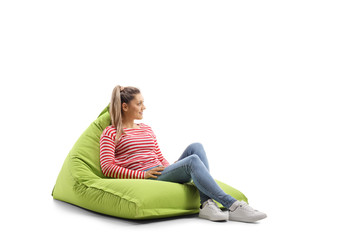 Fototapeta premium Young casual woman sitting on a bean bag