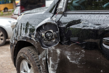 Car accident on road in city. The car crashed. Machine scratched  after an accident stands on...