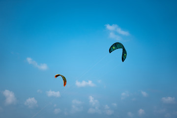two kitesurf sails in the blue sky