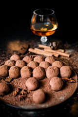 Dark chocolate truffles on black background 