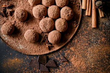 Dark chocolate truffles on black background 