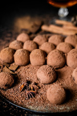 Dark chocolate truffles on black background 