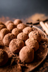 Dark chocolate truffles on black background 