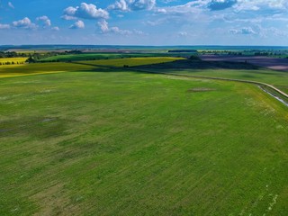 Aerial view of green field  in Minsk Region of Belarus