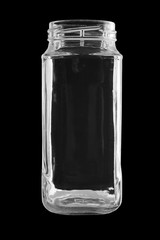 the empty glass jar is isolated on a black background