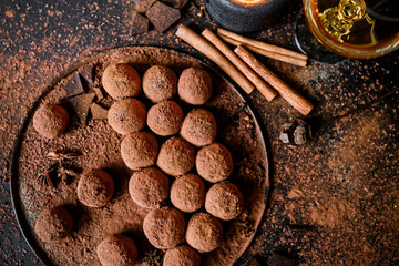 Dark chocolate truffles on black background 