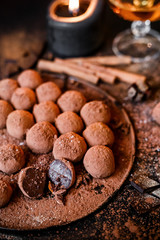 Dark chocolate truffles on black background 