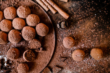 Dark chocolate truffles on black background 