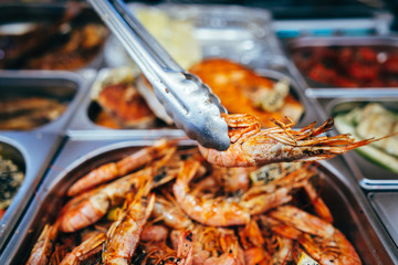 tray with many fried shrimp in the street restaurant