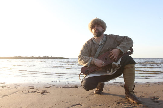 Man Reenactor Playing Gusli