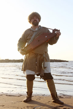 Man Reenactor Playing Gusli