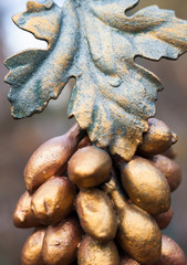 Fototapeta na wymiar Metal grapes bunch and leaf. Forged ornament.