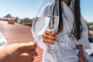flirting couple with sparkling wine on a roof