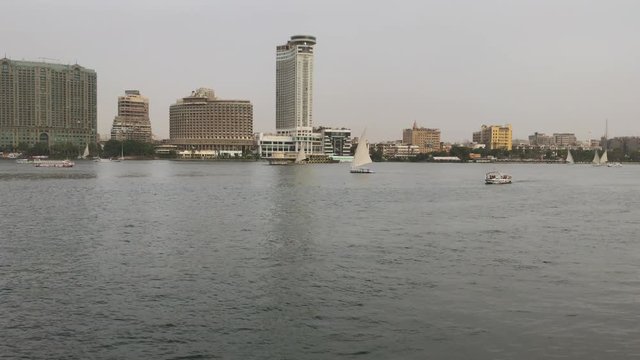 Boats cruise along the Nile River with Cairo in the background