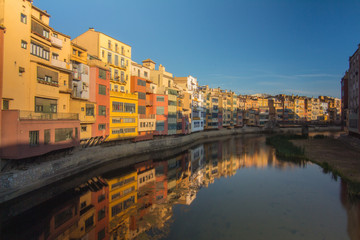 Girona buildings close to river during clear sunset