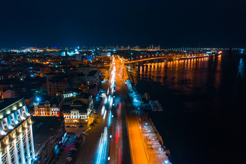 Fototapeta na wymiar Highway at night in modern city. Aerial view of cityscape