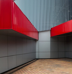 Modern building. Gray and red metal walls.