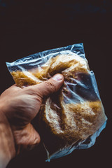 Hand holding rice in plastic bag