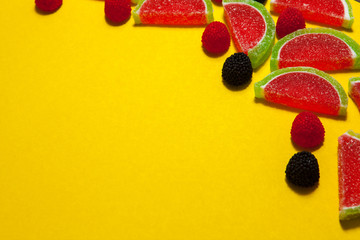 Fruit jelly segments in the form of watermelon on yellow