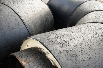 Stack of new gray metal pipes (tubes)