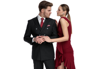 Passionate couple looking while she is romantically touching his arm