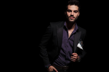 Serious looking man holding his hand in his pocket