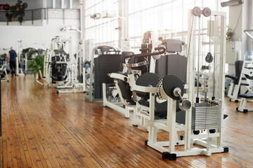 Fototapeta na wymiar Gym interior with equipment. Training equipment in modern gym. Fitness center background.