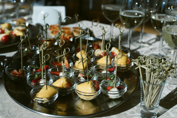 Buffet table in the sun. Red caviar tartlets and strawberry and cheese lolly sandwiches.