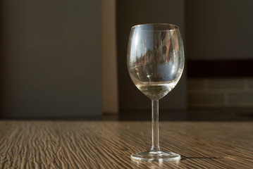 one glass with white dry wine on the table