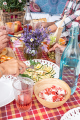 Adult people enjoy food together. Hands take something on the table. Mix of vegetables, eggs and pizza. Family brunch