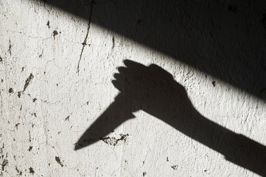 Shadow of the hand holding a knife