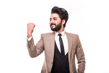 Happy arab young man triumphing with raised hand isolated on white background