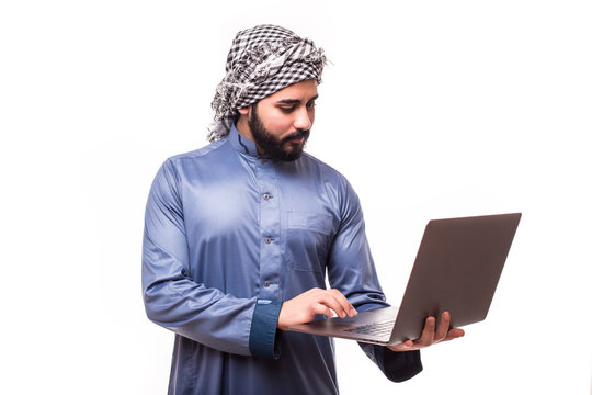 Young arab handsome man in traditional abaya clothes with laptop isolated on white background